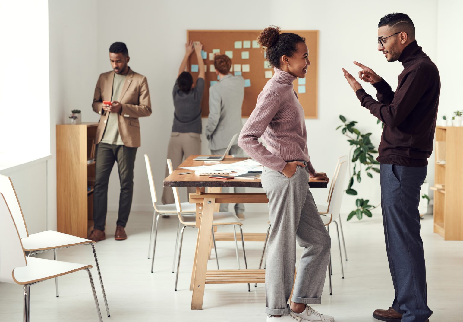 Hive5 colleagues discussing ideas in the office