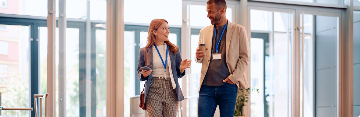 Hive5 colleagues talking in a bright office corridor